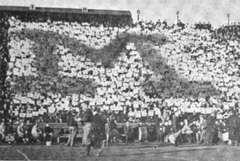 Block M formed by yellow and blue pennants at 1910 Michigan-Minnesota game Ferry Field
