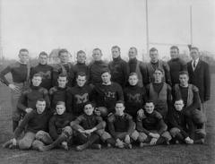 1910 Michigan football team posing in uniform for a team photograph
