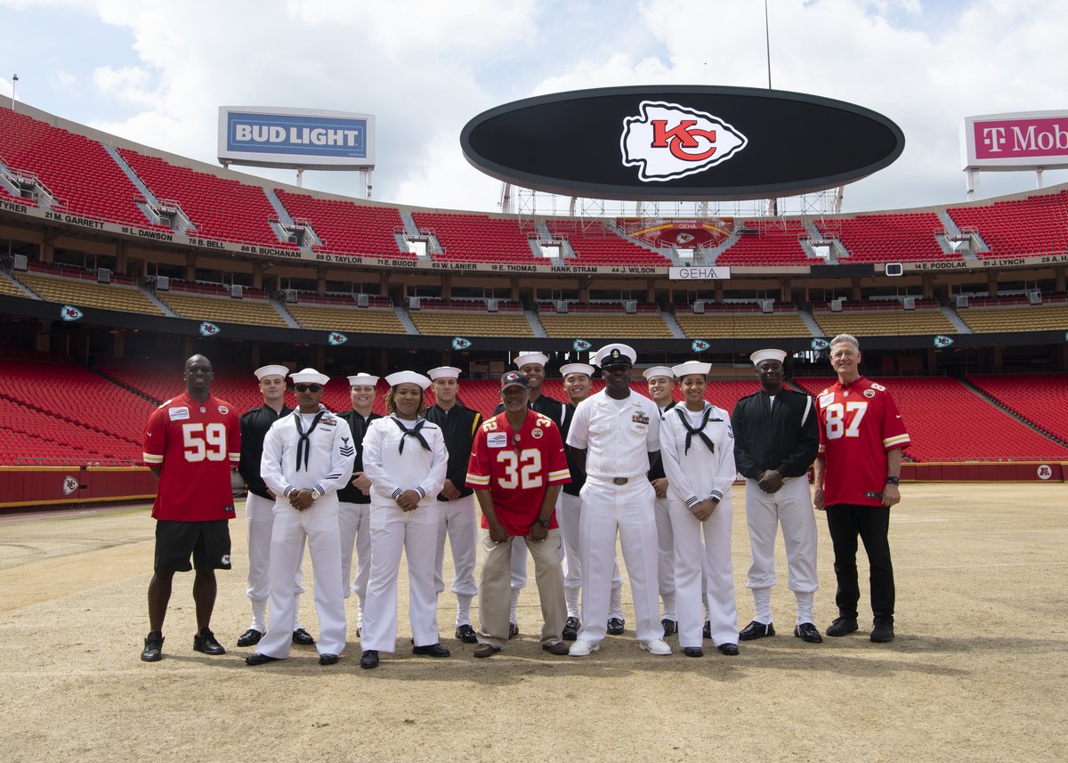 Sailors from USS Harry S. Truman and U.S. Navy Ceremonial Guard Drill Team posing with Kansas City Chief Ambassadors at GEHA Field at Arrowhead Stadium during Kansas City Navy Week 2021