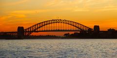 Sydney Harbour Bridge at sunset with colorful sky and city skyline