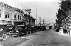 Historical street view of West Flagler Street in Miami, Florida, 1921, showing early 20th-century urban architecture and vehicles.