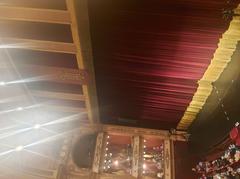 Stage inside Teatro Avenida with red theater seats and elegant decor