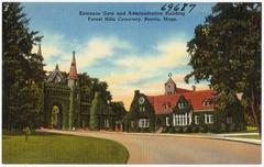 Entrance gate and administration building at Forest Hills Cemetery, Boston, featuring a long avenue bordered by various trees and plants