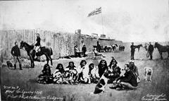 First Nations group seated at historic Fort Calgary site with North-West Mounted Police post