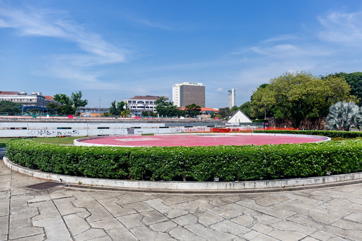 Open grassy area inside Fort Cornwallis with historical walls and greenery