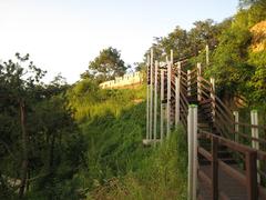 Seoul city wall in August 2007 with stone fortifications and trees