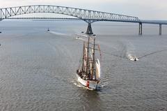 US Coast Guard Cutter Eagle sailing under Francis Scott Key Bridge in Baltimore Harbor during OpSail 2012