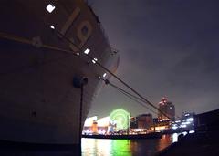 USS Blue Ridge moored at Central Pier in Osaka near aquarium and large ferris wheel