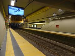 West Platform at a railway station with trains and overhead bridges