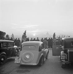 Sunset view from Pincio overlooking St. Peter's Basilica with cars and people arriving in Rome, December 1937