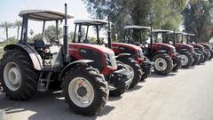 Brand new ArmaTrac 854e tractors lined up at University of Baghdad Agriculture College parking lot during agricultural cooperatives opening in Abu Ghraib Iraq March 2011