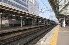 Platforms at Gakuen-mae Station on Kintetsu Nara Line with tracks and overhead electrical wires