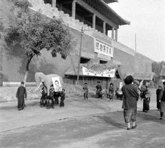 Group carrying a paper elephant with Dewey's portrait and banners supporting Dewey in a 1948 Beijing parade