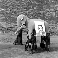 Group carrying a large elephant model with Dewey's portrait, banners reading Good Luck Dewey, celebrating Dewey's 1948 US election campaign in Beijing