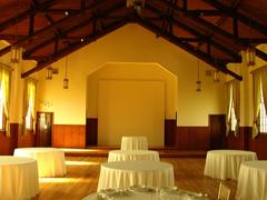 Interior setup of a chapel with many arranged tables and chairs