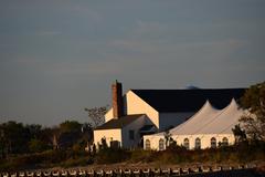 Back view of a chapel and event tent in a green outdoor setting