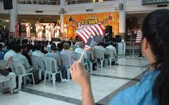 Atlantic Fleet U.S. Navy Showband performing at Manila's Glorietta Mall with audience waving U.S. flags during USNS Mercy humanitarian deployment