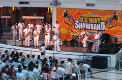 US Navy Showband performing at Manila's Glorietta Mall with Musician 3rd Class Rachel Lucterhand receiving a rose from a fan during USNS Mercy humanitarian deployment