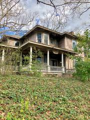 Scenic view of Cherokee Avenue in Grant Park, Atlanta with trees, historic homes, and blue sky