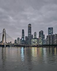 Guangzhou city skyline illuminated at night with skyscrapers and bright lights