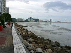 Gurney Drive seafront promenade in Penang Malaysia with buildings and palm trees