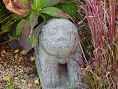 Small statue of a playful boy peeking out from ground at Gwanghwamun Plaza