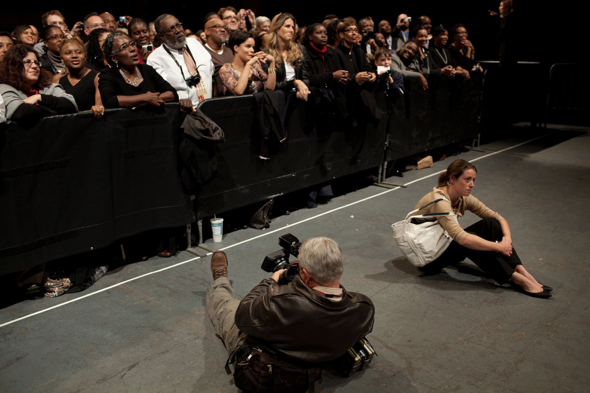 Associate Director of Press Advance Katie Hogan listening to President Barack Obama at Democratic National Committee fundraiser in 2009