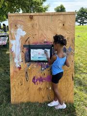 Child painting during summer camp at Hampton National Historic Site