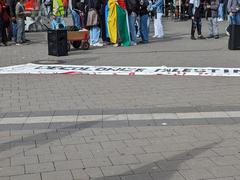 Pro-Palestine demonstration at Münster Westf Hauptbahnhof with protestors holding flags and banners