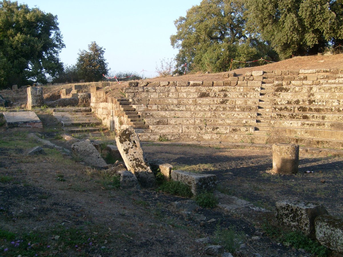 Ancient ruins of the Theatre of Tusculum with stone seating and stage area