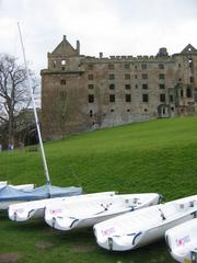 Sailing boats on Linlithgow Loch with surrounding greenery in West Lothian, Scotland