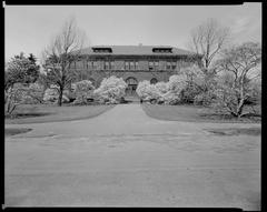 Building and path in Arnold Arboretum with trees and greenery