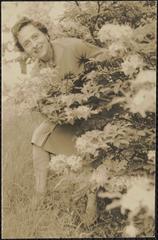 Verna Warren posing next to bushes and flora in Arnold Arboretum