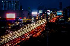Nighttime cityscape of Lima with illuminated buildings and dark sky