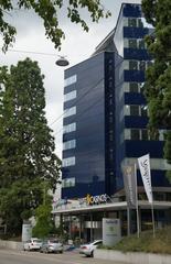 Radisson Blu Hotel in St. Gallen with modern glass exterior and blue sky