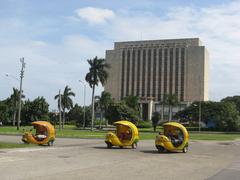 Three-wheeled yellow Coco taxis lined up in Havana Cuba