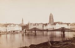 View across the Main River in Frankfurt featuring the Iron Footbridge and cathedral, historic black and white albumen print from 1868-1871 by Carl Friedrich Mylius
