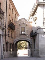 Street view of Calle de Madrid next to Plaza de la Villa in Madrid, Spain, showing the passage between Casa de la Villa and Casa de Cisneros buildings