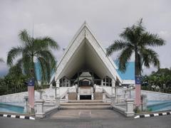 Istana Budaya building in Kuala Lumpur with modern architecture and water reflection