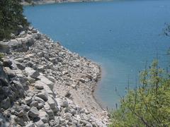 Scenic view of Hippie Hollow Park with a rocky shoreline and people relaxing