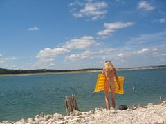 Scenic view of Hippie Hollow Park with clear water and rocky shoreline in Austin, Texas