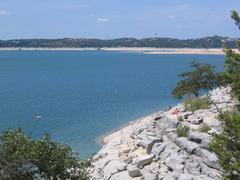Scenic view of Hippie Hollow Park in Austin Texas with rocky shore and calm water