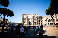 Ancient Roman ruins with columns and arches under a partly cloudy blue sky