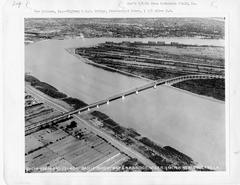 1940 aerial photo of Huey P Long Bridge and Mississippi River bend near Nine Mile Point with Uptown New Orleans in distance