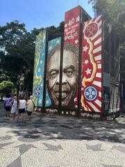 Artwork representing Gilberto Gil at Praça Floriano Peixoto, Cinelândia with the phrase 'Alô Rio de Janeiro, aquele abraço!'
