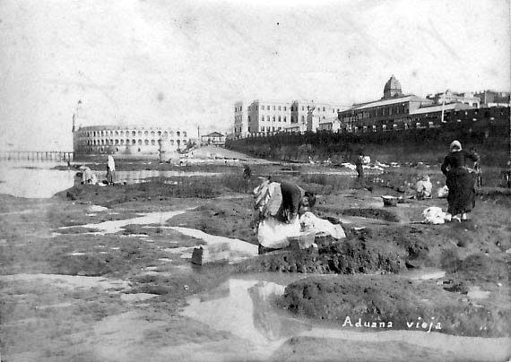 Historical view of Buenos Aires waterfront with women washing clothes in River Plate pits, Casa Rosada and Taylor Customs building in background