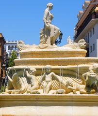 Fuente de Híspalis fountain in Sevilla with surrounding greenery and people
