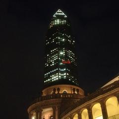 Night view of the Messeturm skyscraper in Frankfurt with illuminated windows