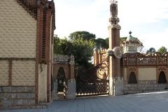 Finca Güell architectural entrance with ornate iron gates and detailed stonework
