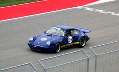 Vintage race cars lined up on the track at the 2014 Circuit of the Americas event